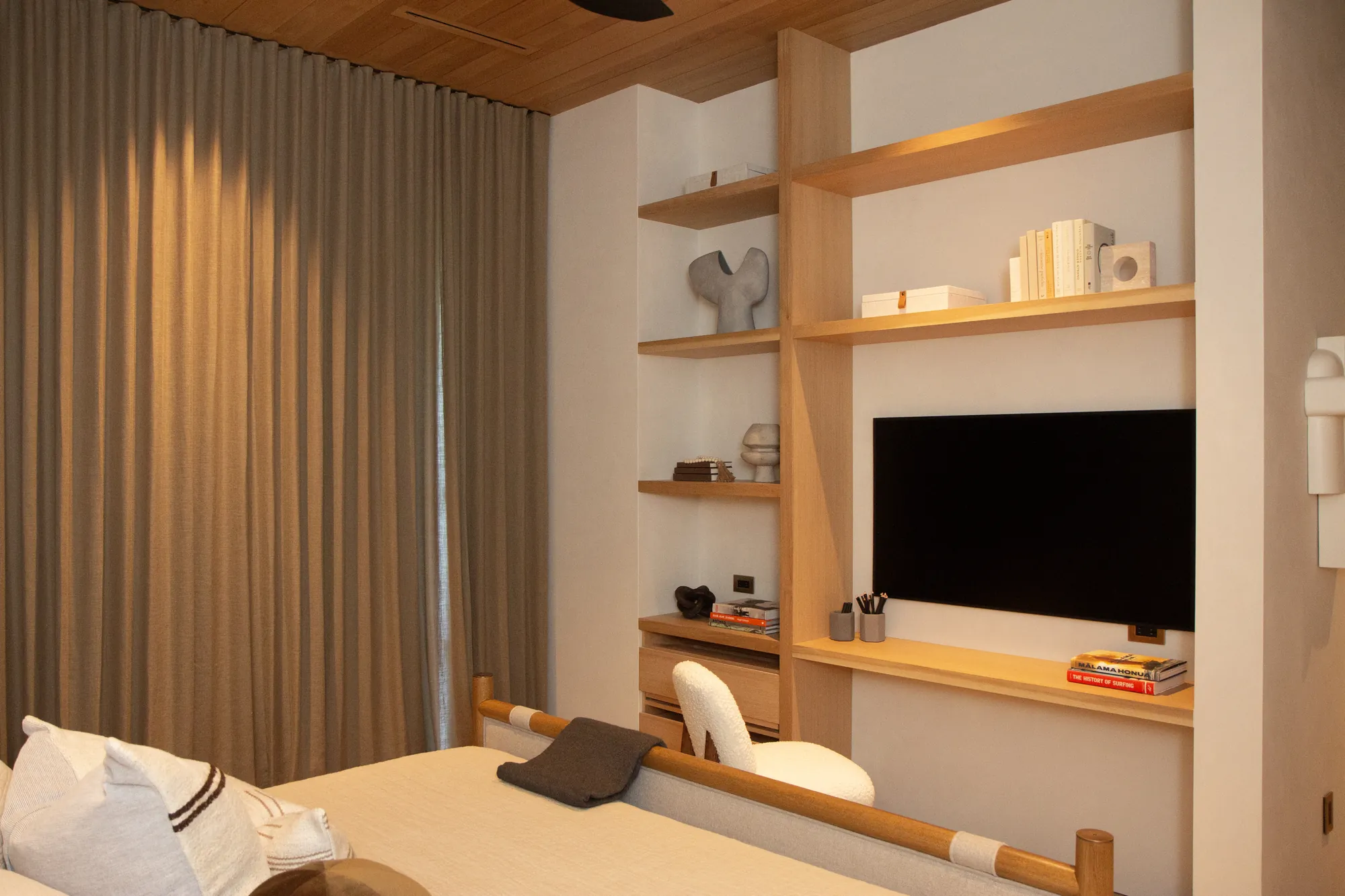 Recessed drapery and built-ins in a warm bedroom